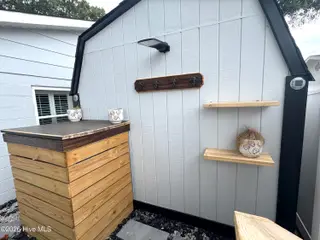 113 NW 12th Street, Oak Island, NC 28465 – photo 18: Shelving on Back of Shed