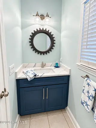 301 Wisteria Way, Caswell Beach, NC 28465 – photo 12: half bath
