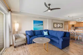 212 Old Causeway Road 107 & B13 Slip, Beaufort, NC 28516 — 3-bedroom condo in Morgan Creek Landing, Beaufort, NC, photo 5 of 49: Living room with covered balcony access