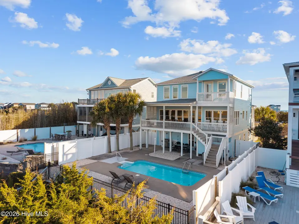 6634 Kings Lynn Drive, Oak Island, NC 28465 – photo 1 of 63: 52-web-or-mls-DJI_20260216160706_0520_D