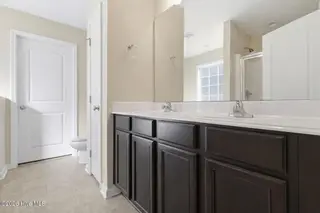 404 Hidden Oaks Drive, Jacksonville, NC 28546 – photo 17: Modern bathroom with double vanity
