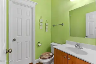 390 E Second Street, Ocean Isle Beach, NC 28469 – photo 12: Half bath with supply closet