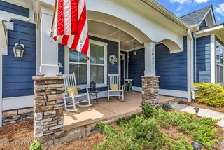 3032 Eno Lane, Leland, NC 28451 — 4-bedroom home in Brunswick Forest, Leland, NC, photo 2 of 55: Front Porch