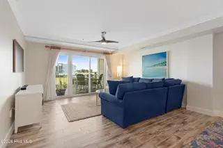 212 Old Causeway Road 107 & B13 Slip, Beaufort, NC 28516 — 3-bedroom condo in Morgan Creek Landing, Beaufort, NC, photo 15 of 49: Living room with covered balcony access