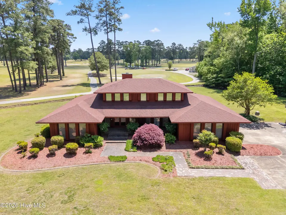 201 Country Club Drive, Elizabeth City, NC 27909 — 3-bedroom home in Country Club Forest, Elizabeth City, NC, photo 1 of 58: 049 ccd 260504 ext front drone 3