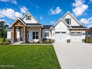 914 Maggie Lane, Elizabeth City, NC 27909 – photo 2: Modern Farmhouse Exterior with Lush Land