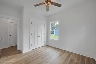 82 Northeast Drive NW, Calabash, NC 28467 – photo 21: 82NE 3rd bedroom with closet & view of c