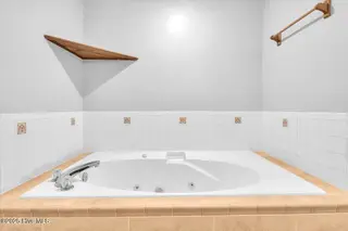 127 NW 19th Street, Oak Island, NC 28465 – photo 20: Ensuite bath with jetted tub