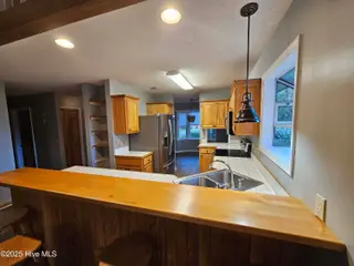 3235 Marsh View Drive SW, Supply, NC 28462 — 3-bedroom home in Lockwood Folly, Supply, NC, photo 6 of 36: Kitchen to Dining