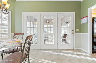 9 Golf Crest Court, Carolina Shores, NC 28467 — 3-bedroom home in Carolina Shores, Carolina Shores, NC, photo 9 of 46: Doors to Screened Porch