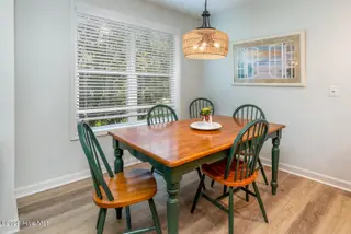 3350 Club Villas Drive 104, Southport, NC 28461 — 2-bedroom condo in St James, Southport, NC, photo 10 of 34: Wooded View from Dining Area