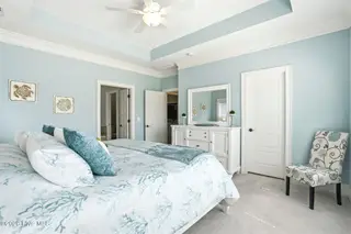 6479 Bryson Drive SW, Ocean Isle Beach, NC 28469 – photo 20: Trey ceiling/double doors to ensuite