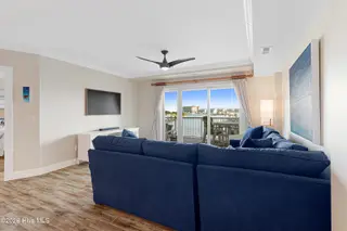 212 Old Causeway Road 107 & B13 Slip, Beaufort, NC 28516 — 3-bedroom condo in Morgan Creek Landing, Beaufort, NC, photo 4 of 49: Living room with covered balcony access