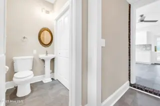 207 N 13th Street, Wilmington, NC 28401 — 4-bedroom home, Wilmington, NC, photo 19 of 39: Half bath view into the kitchen