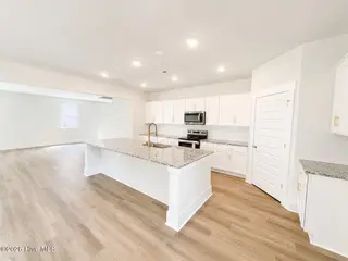 8611 Blue Haw Way Lot 124, Leland, NC 28451 — 5-bedroom home in Indigo Preserve, Leland, NC, photo 11 of 33: Large Island Kitchen