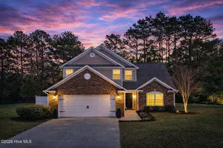 14 Calabash Lakes Boulevard, Carolina Shores, NC 28467 – photo 12: Twilight serenity in suburban home