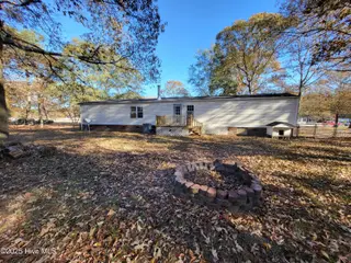 119 Edgewater Lane, Richlands, NC 28574 — 2-bedroom manufactured home in Chapel Ridge, Richlands, NC, photo 11 of 34: Backyard, Firepit