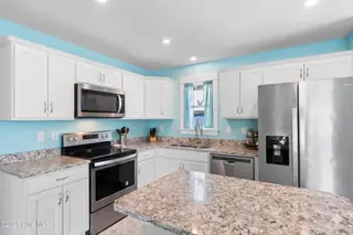 229 NE 75th Street, Oak Island, NC 28465 – photo 10: 229NE75thSt - 15 clutter removed by Gemi