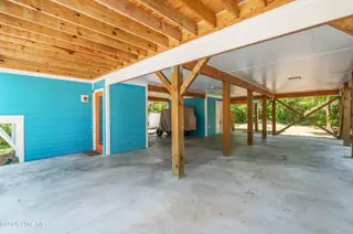 119 NE 27th Street, Oak Island, NC 28465 – photo 21: carport with golf cart
