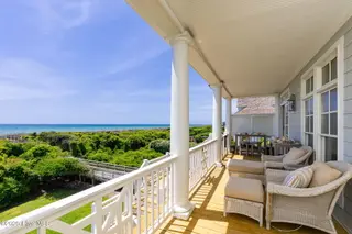 125 Roosevelt Drive, Pine Knoll Shores, NC 28512 — 5-bedroom home in Roosevelt Beach, Pine Knoll Shores, NC, photo 4 of 61: Covered porches on ocean side of home