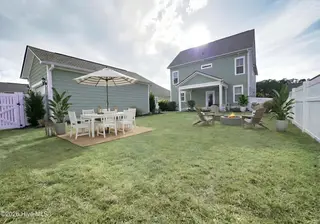 9154 Village Lake Drive SW, Calabash, NC 28467 – photo 8: Backyard with firepit