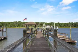 104 SW Yacht Drive, Oak Island, NC 28465 — 5-bedroom waterfront home, Oak Island, NC, photo 3 of 77: 90_boardwalk