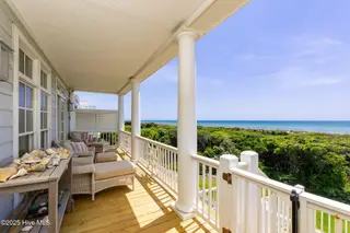 125 Roosevelt Drive, Pine Knoll Shores, NC 28512 — 5-bedroom home in Roosevelt Beach, Pine Knoll Shores, NC, photo 19 of 61: Covered porch off living space