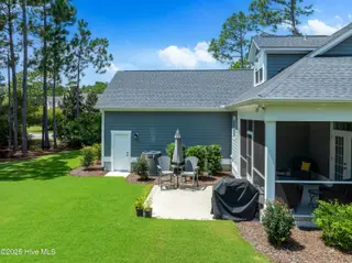 3997 Wyndmere Drive, Southport, NC 28461 – photo 6: Cozy Rear Patio Off of Screened Patio