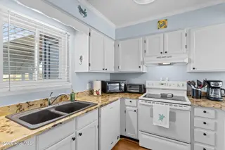 1000 Caswell Beach Road Apt. 806, Oak Island, NC 28465 — 2-bedroom condo in Oak Island Bch Villa, Oak Island, NC, photo 11 of 56: Kitchen with Granite Counter tops