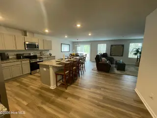 1439 New Sun Drive SE, Bolivia, NC 28422 — 4-bedroom home in Olde Georgetowne, Bolivia, NC, photo 12 of 15: 1439 kitchen dining living