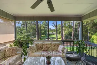 22 Pine Lake Drive, Whispering Pines, NC 28327 – photo 5: Screened Porch Overlooking the Water