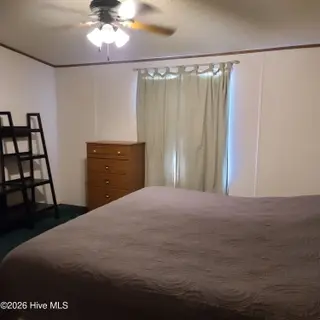 107 Eagle Ridge Drive, Dudley, NC 28333 — 4-bedroom manufactured home in Eagle Ridge, Dudley, NC, photo 11 of 17: Primary Suite