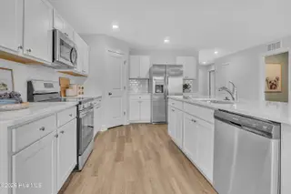 7111 Woodline Drive SW, Sunset Beach, NC 28468 – photo 16: Seaside Palms_Model_Venture_6911 Seaside