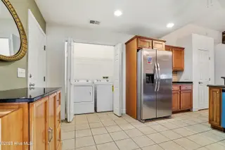 833 Fifty Lakes Drive, Southport, NC 28461 – photo 6: Refrigerator & Laundry Room