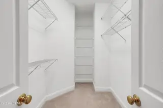 1009 N Sanderling Drive, Leland, NC 28451 — 3-bedroom townhome in Waterford of the Carolinas, Leland, NC, photo 23 of 63: Primary Closet