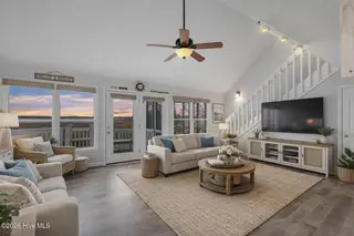 819 S Topsail Drive, Surf City, NC 28445 – photo 4: Coastal living room with sunset view