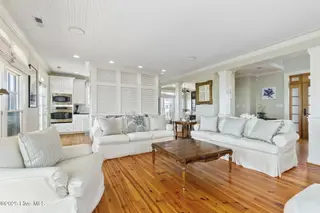 125 Roosevelt Drive, Pine Knoll Shores, NC 28512 — 5-bedroom home in Roosevelt Beach, Pine Knoll Shores, NC, photo 16 of 61: Light-filled LR w/ fireplace