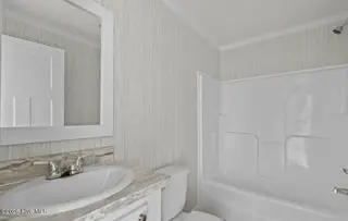6823 Lewis Drive SE, Winnabow, NC 28479 – photo 20: Guest bathroom