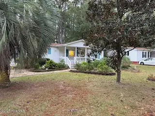 243 Ocean Forest Drive NW, Calabash, NC 28467 — 3-bedroom manufactured home in Ocean Forest, Calabash, NC, photo 3 of 61: Front of house with yard