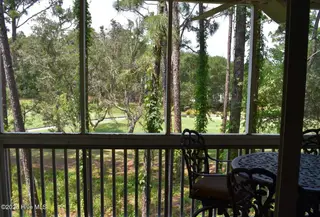 3350 Club Villas Drive 104, Southport, NC 28461 — 2-bedroom condo in St James, Southport, NC, photo 16 of 34: Golf View thru Porch