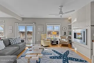 7403 E Beach Drive, Oak Island, NC 28465 – photo 15: Sunlit Living Room with Ocean Views