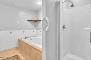 127 NW 19th Street, Oak Island, NC 28465 – photo 19: Ensuite bath with jetted tub